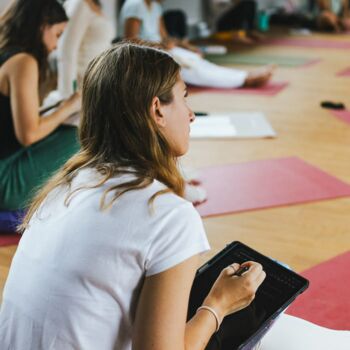 Gruppe sitzt im Theorie Unterricht der Yogaausbildung 200h der Yogaschule Yoga-Veda-Ausbildungen